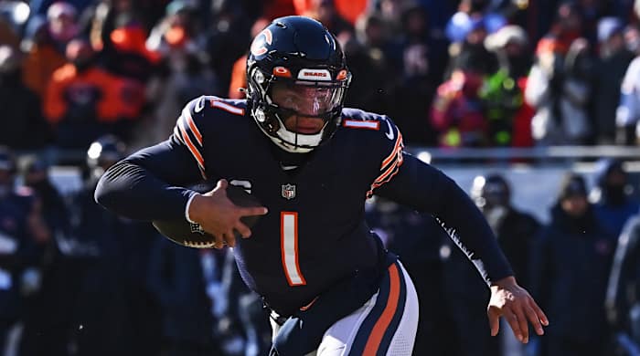 Bears quarterback Justin Fields runs with the ball.